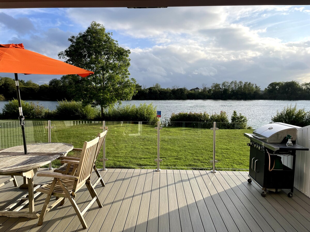 Private decking and garden looking across Spring Lake